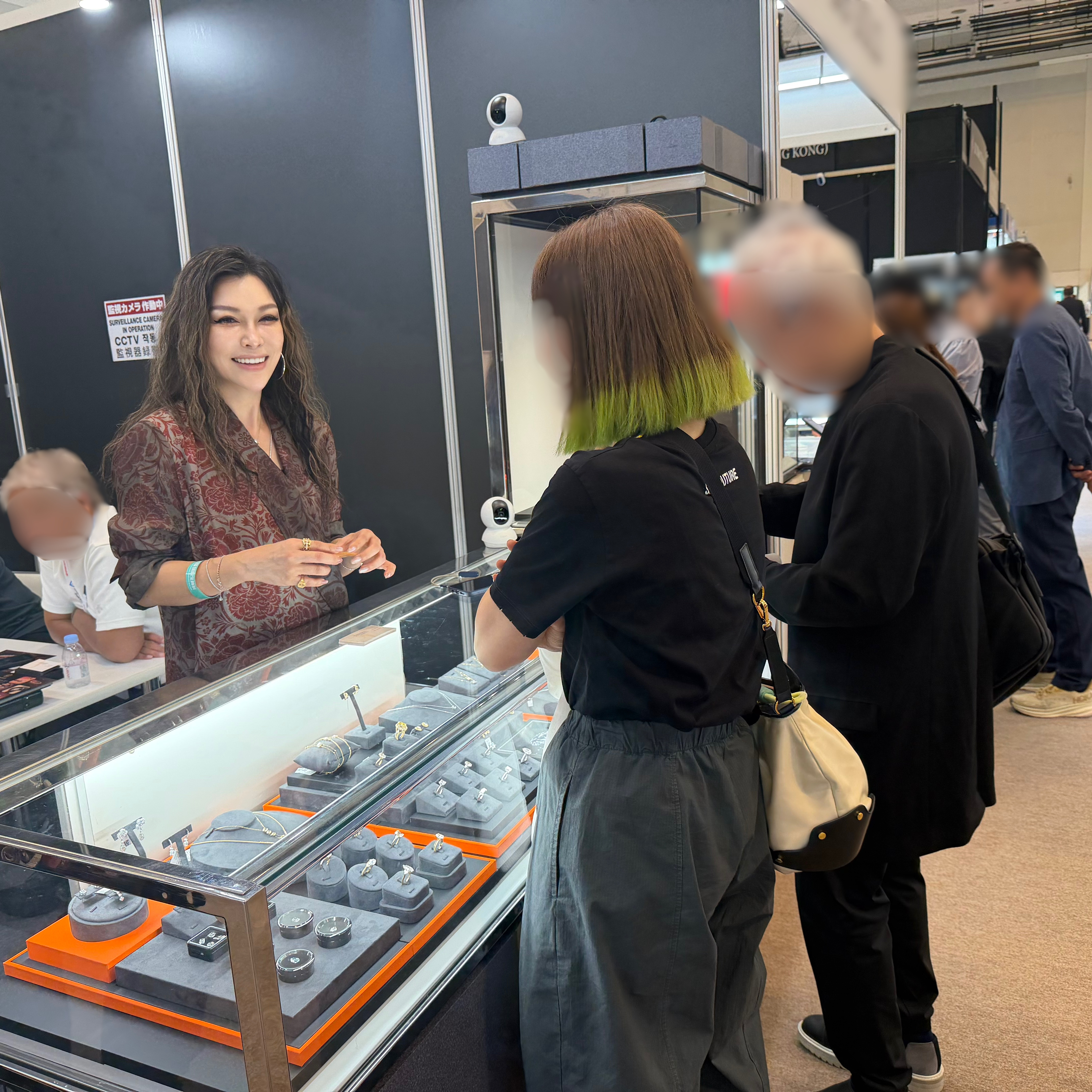Visitors viewing Gwen’s Glow Jewelry Inc. products at the booth
